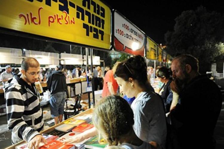 מבקרים מעיינים בספרים בשבוע הספר העברי בגן הפעמון בירושלים, 2009. 
הצילום: AMOS BEN GERSHOM, לע"מ
